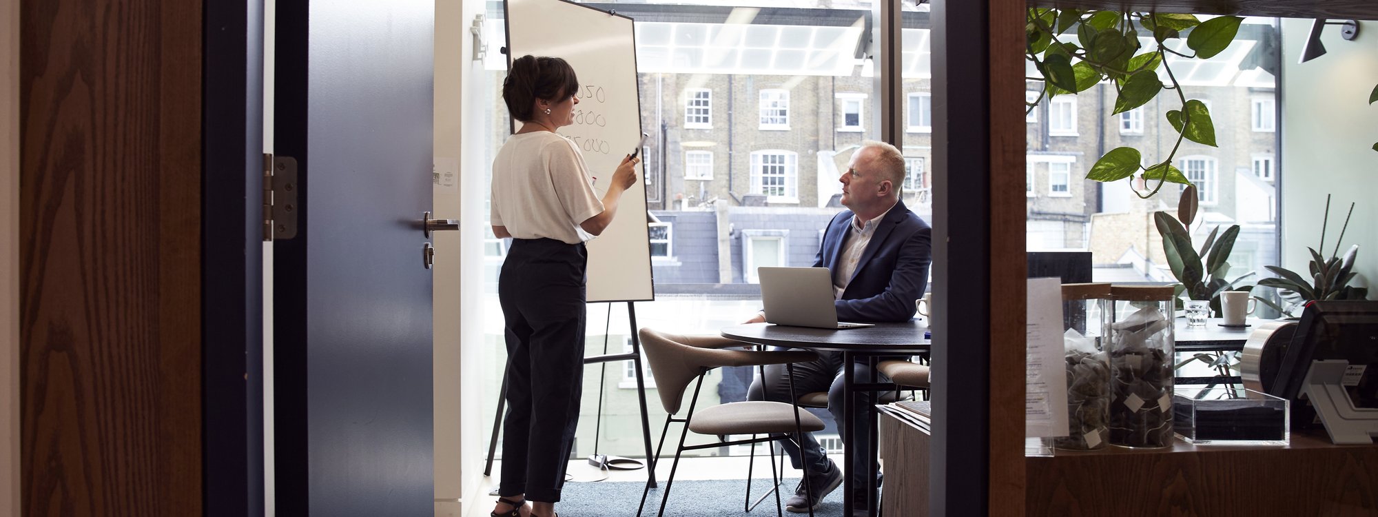 One-on-one business consultant meeting between executive and mentor One-on-one business consultant meeting between executive and mentor