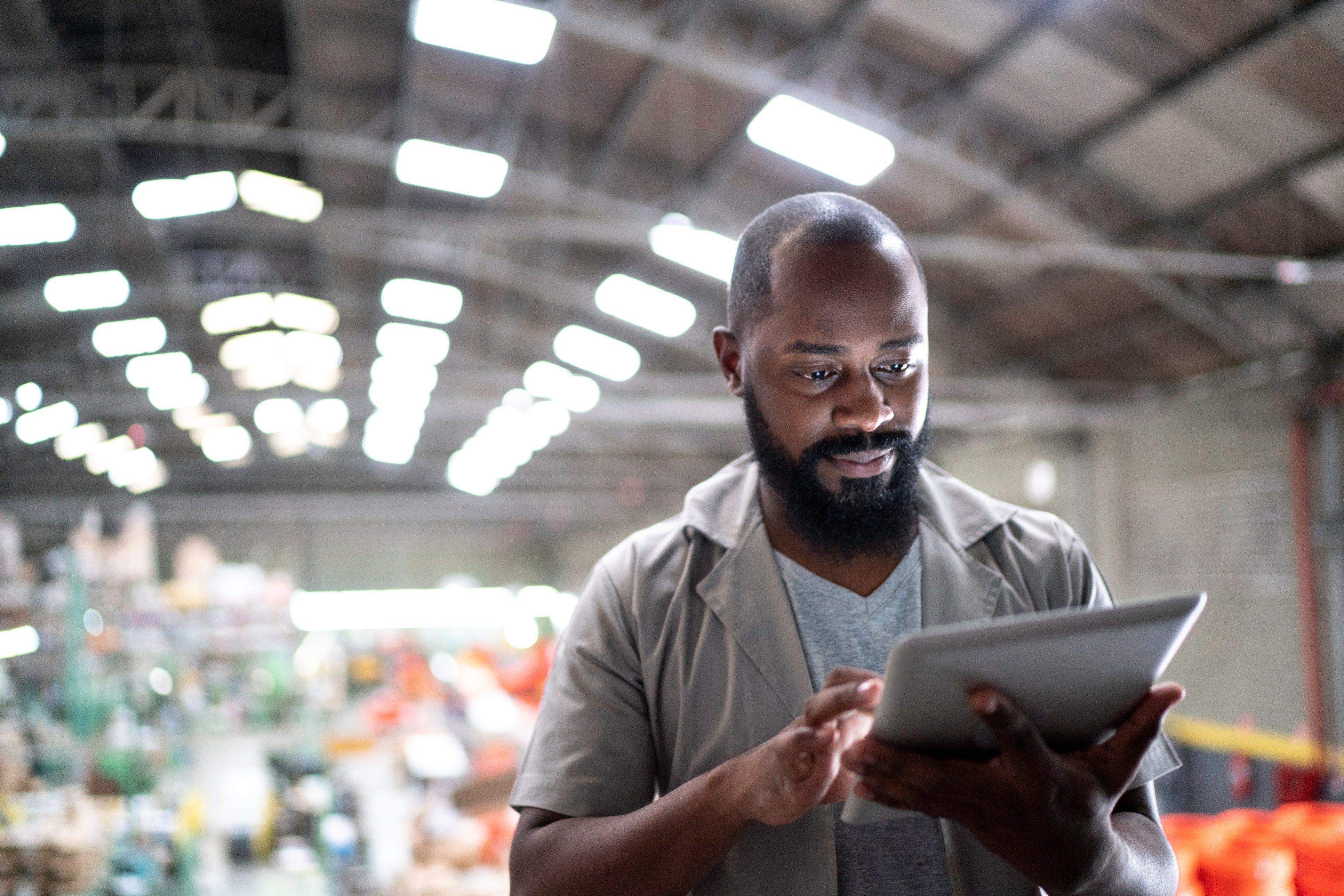 Warehouse worker using a tablet to manage data digitally in real time