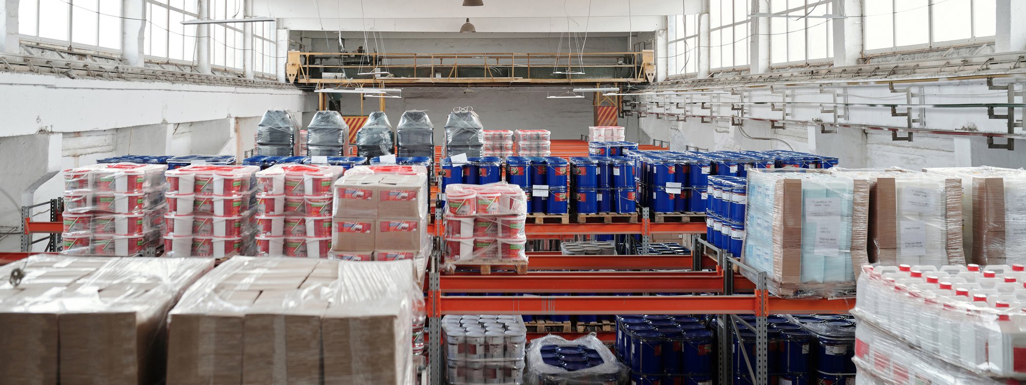 Interior warehouse photo displaying organized inventory on pallets and pallet racking